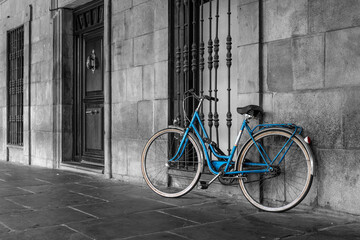 blue classic bike parked on old town street.