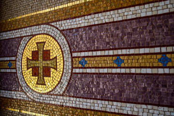 Byzantine cross mosaic on a wall with a copy space.