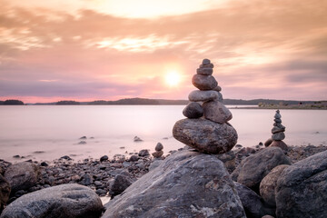 Balance stones on the beach at sunset. Zen concept, harmony and meditation.