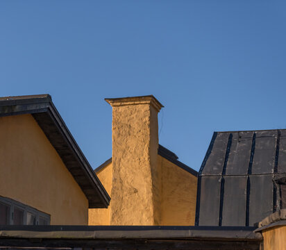 Tin Roofs And A Chimney On An Old 1700s Plastered Yellow House A Sunny Winter Day In The Island Djurgården In Stockholm