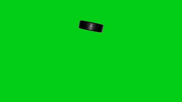 Hockey pack flies into camera on chromakey background. Sports concept.