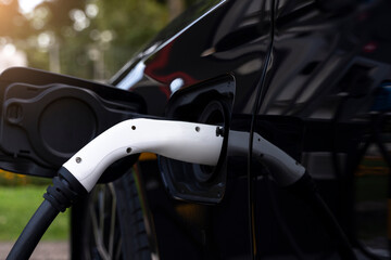 Fototapeta na wymiar Electric Vehicle 'EV' charging at public charge point.