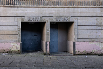 two old blue doorways leading out into the street