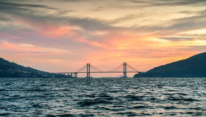 suspension bridge at sunset, in the Vigo estuary, Galicia, Spain.