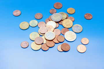 a handful of euro cent coins on a blue background