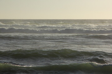 Fototapeta na wymiar olas de mar en el inicio de la puesta de sol, fuerza del mar