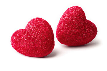 Two red marmalade hearts in shiny sugar crystals, close-up, isolated on a white background. Valentine's Day concept.