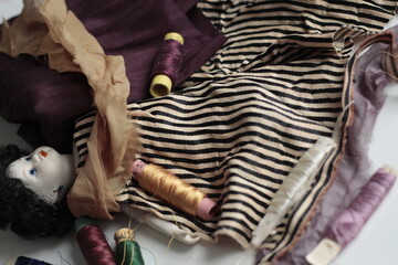 Fototapeta na wymiar doll dress, fabrics, threads, needlework, antique doll, antique toy
