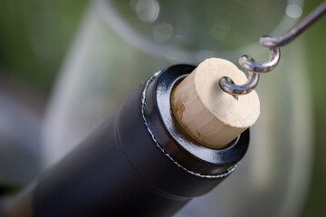 Close-up of Corkscrew Twisted Into Cork of Wine Bottle.