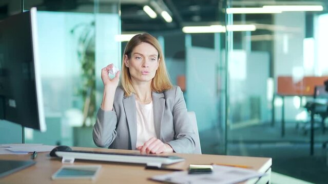 woman is bored at work, does nothing to do the office worker has nothing. businesswoman sitting at desk with computer. Female entrepreneur or employee having fun in a paper throwing game on workplace