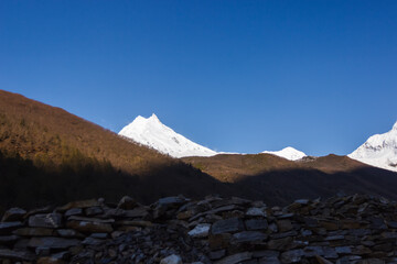 Snow-capped mountain peaks illuminated by dawn in manaslu Himalayas