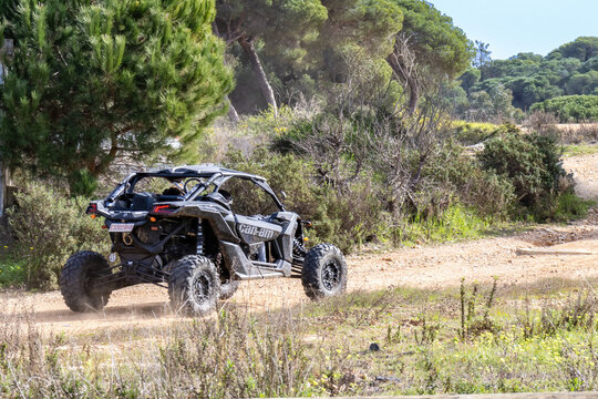 Huelva, Spain - January 29, 2022: Can-am MAVERICK, black all terrain vehicle running by a forest path