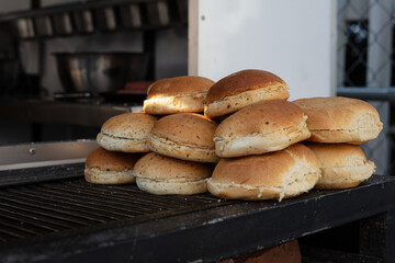 Burger buns on a dark grill