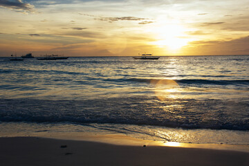 Fototapeta na wymiar Sunset on the coast. Sea and sand. Sunset light. Beautiful nature. Seascape. Tropical climate. Philippines. Boracay Island. Exotic nature.
