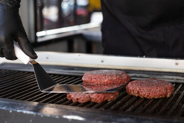 Hamburger meat on the grill about to be prepared