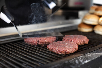 Hamburger meat on the grill about to be prepared