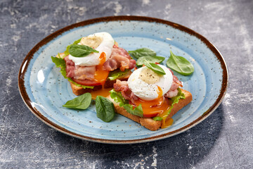toasts with poached egg and bacon