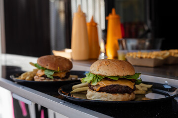 Finished hamburgers on a food truck table