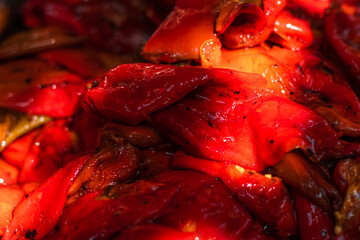 Grilled roasted red bell peppers to make tomato sauce lyutenitsa in Bulgaria. Sunny spots on the peppers. High quality photo