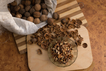 Peeled and shelled walnuts are scattered randomly on the table.