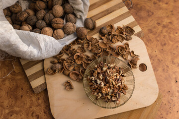 Peeled and shelled walnuts are scattered randomly on the table.