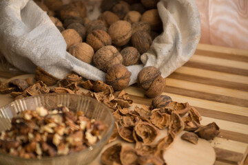 Peeled and shelled walnuts are scattered randomly on the table.