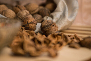 Peeled and shelled walnuts are scattered randomly on the table.