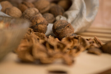 Peeled and shelled walnuts are scattered randomly on the table.