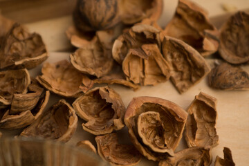 Peeled and shelled walnuts are scattered randomly on the table.