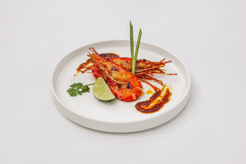 Grilled tiger shrimp with lemon, isolated on white background, top view