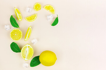 Fruit concept. Fresh organic yellow lemon summer fruit with green leaves, ice cube on minimal pastel creative background