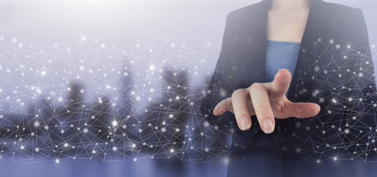 Business network communication and innovation technology concept. Hand touch digital screen hologram data wave sign on city light blurred background.
