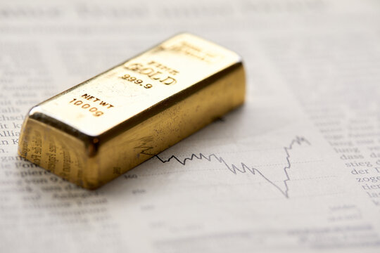 Gold Bullion  On The Graph As Crisis Safe Haven, Financial Asset, Investment And Wealth Concept...