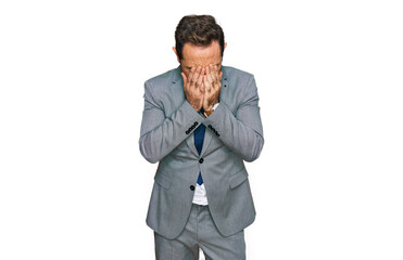 Middle age man wearing business clothes with sad expression covering face with hands while crying. depression concept.
