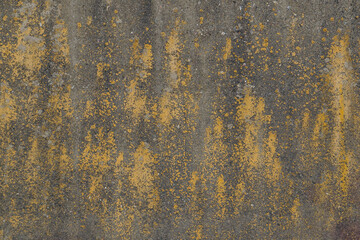 Rough beton wall with old weathered yellow paint. Old plaster shabby surface. Full frame image for texture or background, design concept, copy space