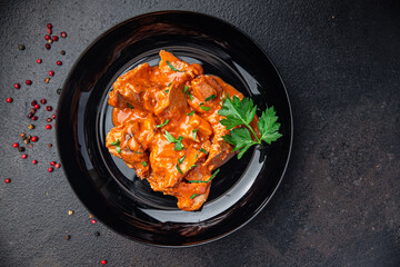 meat tomato sauce spezzatino pork beef lamb fresh portion dietary healthy meal food diet still life snack on the table copy space food background rustic top view keto or paleo diet
