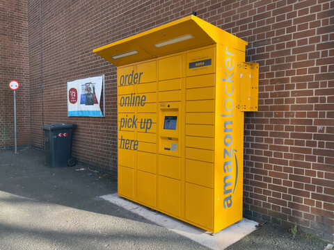 Amazon lockers in an alleyway. Amazon Locker is a self-service package delivery service of parcel lockers. Derby UK - January 29th 2022