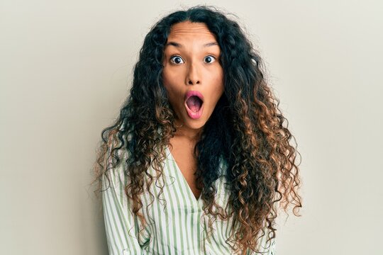 Young latin woman wearing casual clothes afraid and shocked with surprise expression, fear and excited face.