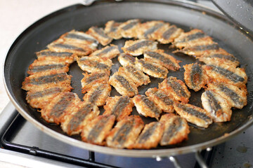Anchovy is fried in a pan, cooking Turkish style anchovy, fried fish,