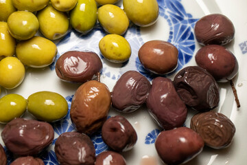 Organic olives in green and black on the breakfast plate.