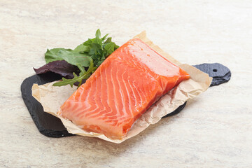 Raw salmon fillet over board