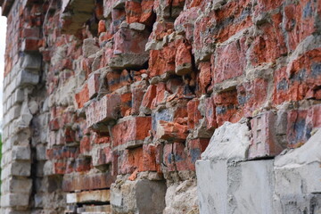 A ruined red brick wall