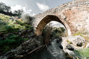 Fototapeta na wymiar Medieval Venetian stone bridge of Akapnou over Vasilikos river. Limassol District, Cyprus