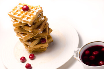 Belgiumm waffles with cherry syrup at white background