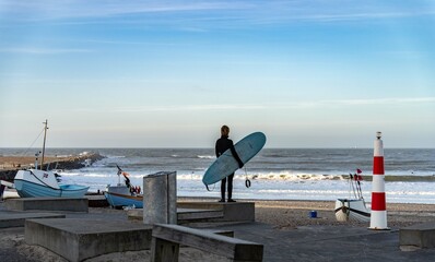 Surfer wait to catching waves in cold water in winter, cold hawaii, norre vorupor, Klitmoller and Hanstholm, denmark - obrazy, fototapety, plakaty