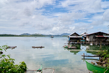 Wooden houses on stilts, tropical village on the sea shore.