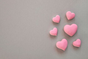 3d pink hearts creative arrangement on neutral background. Concept of love, romantic relationship, heart shape symbol, simple layout, celebration of  wedding, Valentine's Day border background.