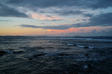 Amazing sunset on Pacific ocean. Waves and foam.