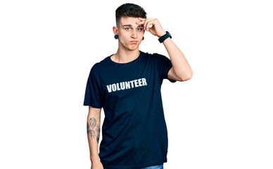 Young caucasian boy with ears dilation wearing volunteer t shirt worried and stressed about a...