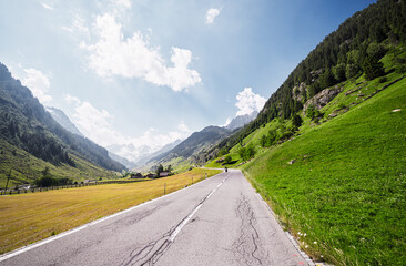 Asphalt road in Alp mountains. Road trip concept. Beautiful landscape.